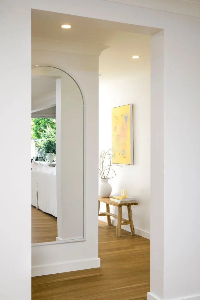 Arched doorway leading to bedroom with yellow accent lighting