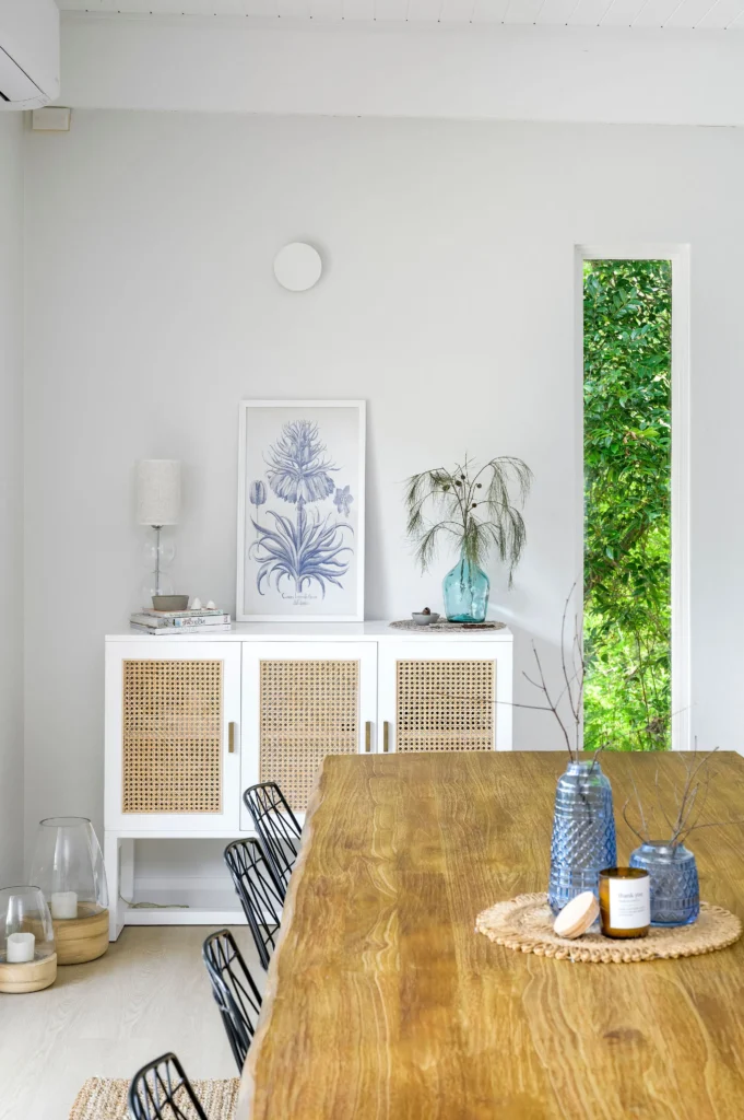 Open plan dining room extension with timber table and garden access through full-height glazing