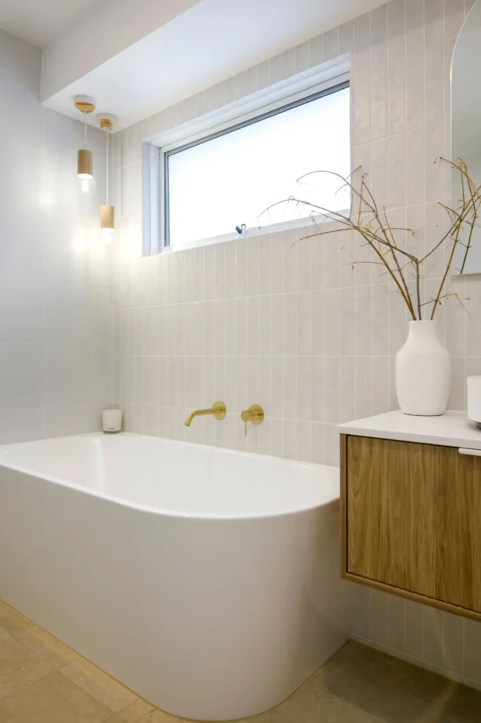 Freestanding bathtub with timber vanity and dried pampas grass